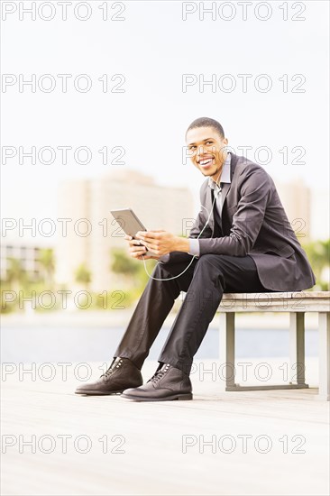 Black businessman using digital tablet outdoors