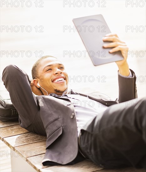 Black businessman using digital tablet outdoors