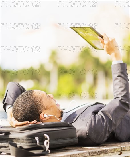 Black businessman using digital tablet outdoors