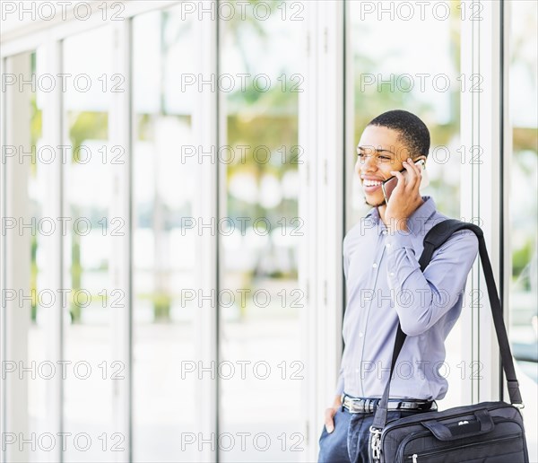 Black businessman talking on cell phone outdoors