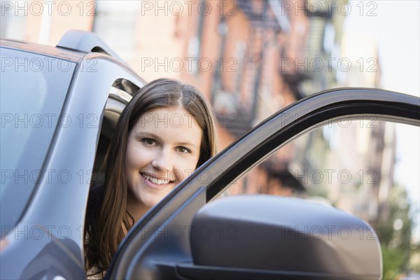 Caucasian woman opening car door