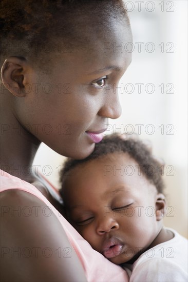 Black mother holding sleeping son