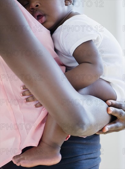 Black mother holding sleeping son