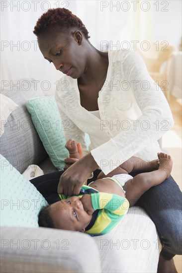 Close up of Black mother changing diaper of baby boy