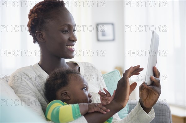 Close up of Black mother and baby boy using digital tablet