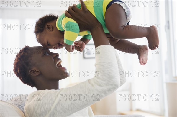 Black mother playing with baby boy