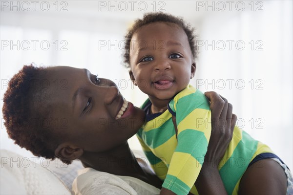 Black mother holding baby boy