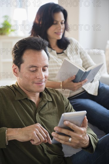 Couple reading in living room