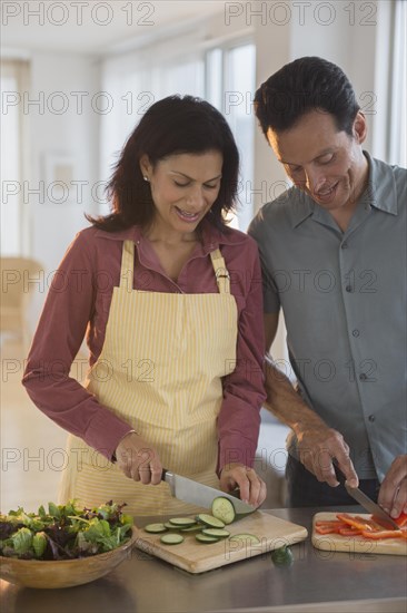 Couple chopping vegetables in kitchen