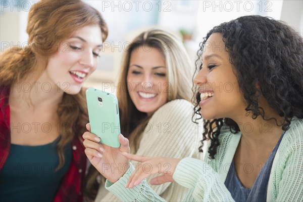 Close up of women using cell phone