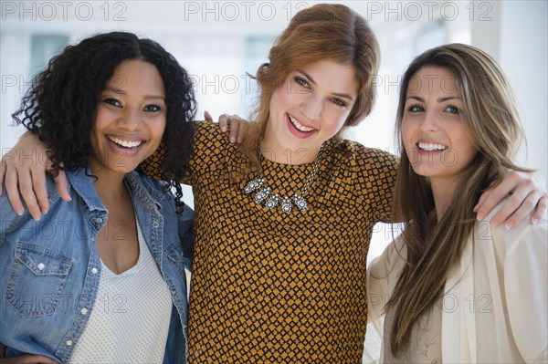 Close up of smiling women hugging