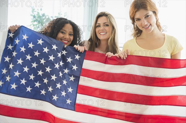 Smiling women holding American flag