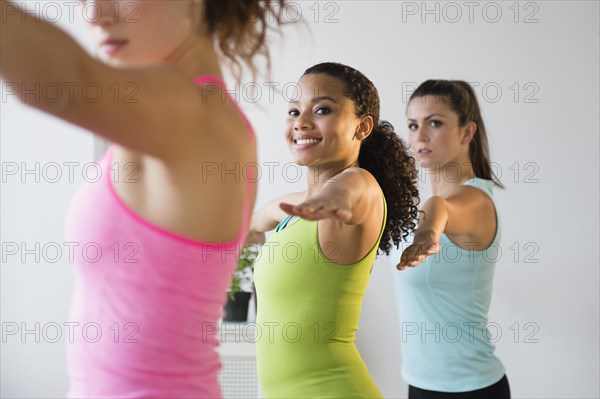 Women practicing yoga in class