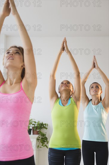 Women practicing yoga in class