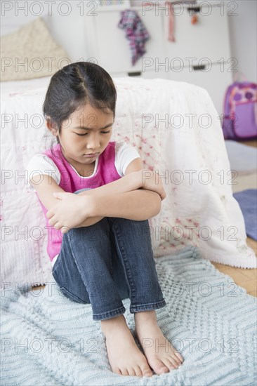 Vietnamese girl pouting in bedroom