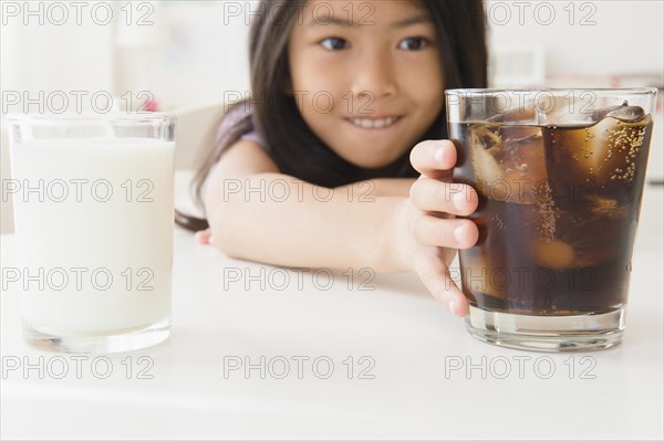 Vietnamese girl choosing glass of soda