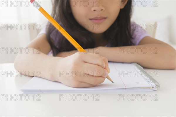 Close up of Vietnamese girl doing homework