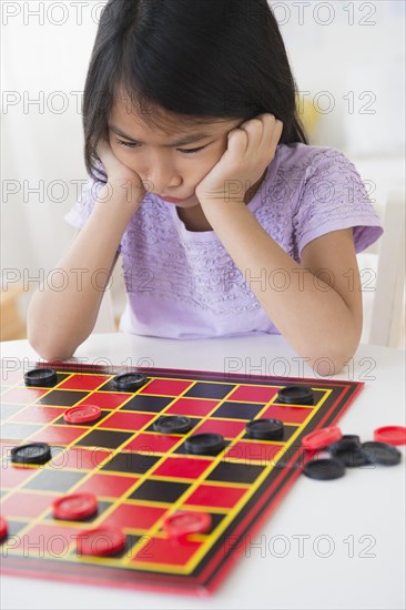 Frustrated Vietnamese playing checkers game
