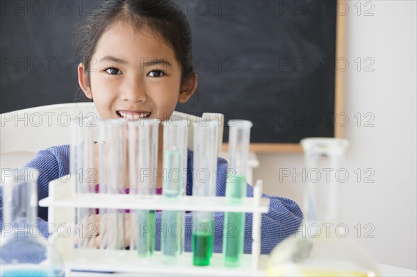 Vietnamese student doing science experiment in classroom