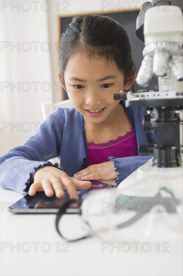 Vietnamese student doing science experiment in classroom