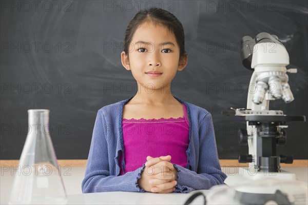 Vietnamese student doing science experiment in classroom