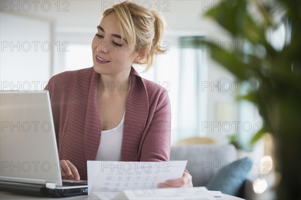 Caucasian woman paying bills online