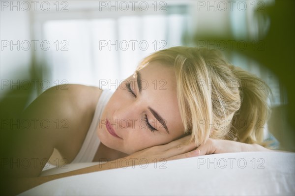 Caucasian woman sleeping in bed