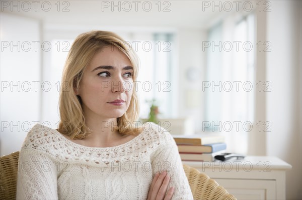 Lonely Caucasian woman sitting in living room