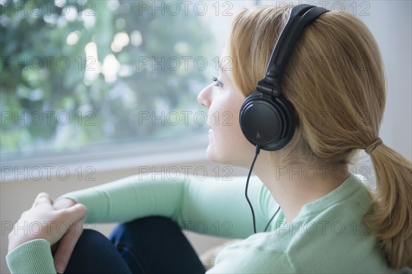 Caucasian woman listening to headphones