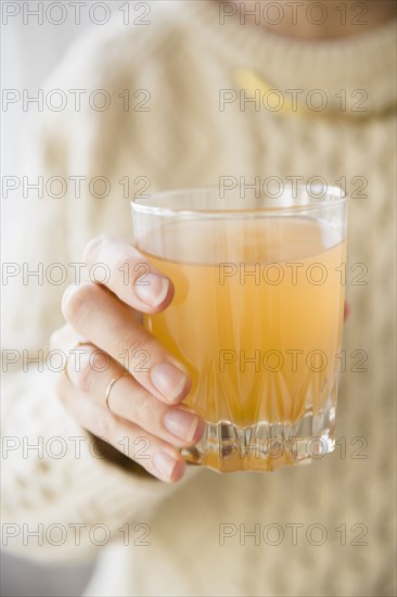 Close up of Caucasian woman holding glass of punch
