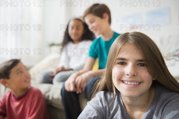 Girl smiling with friends in living room