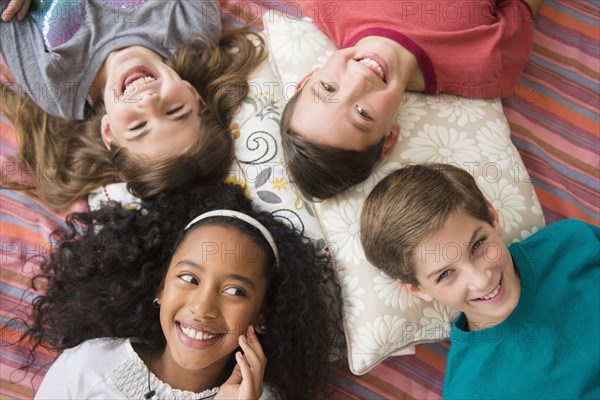 Smiling children laying in circle