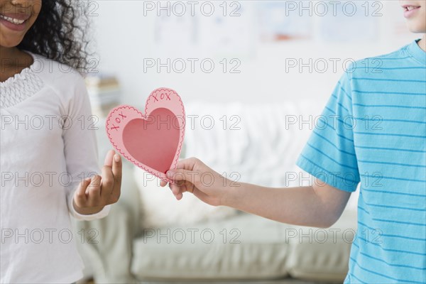 Boy passing Valentine to friend