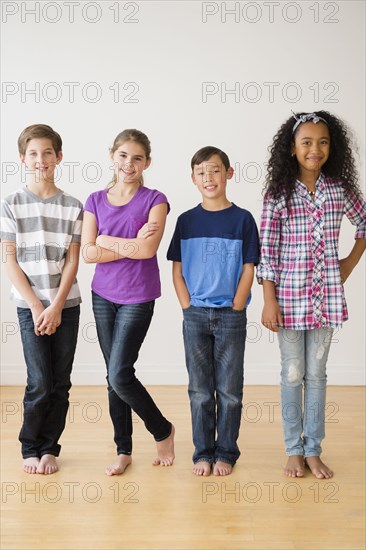 Barefoot children smiling in studio