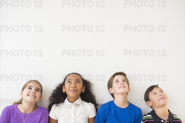 Smiling children thinking and looking up