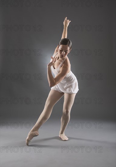 Hispanic ballet dancer posing on tip toe