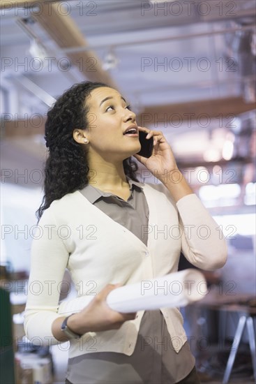 Mixed race architect talking on cell phone