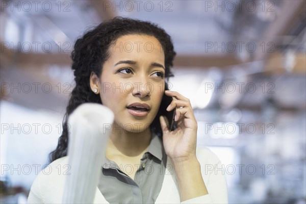 Mixed race architect talking on cell phone