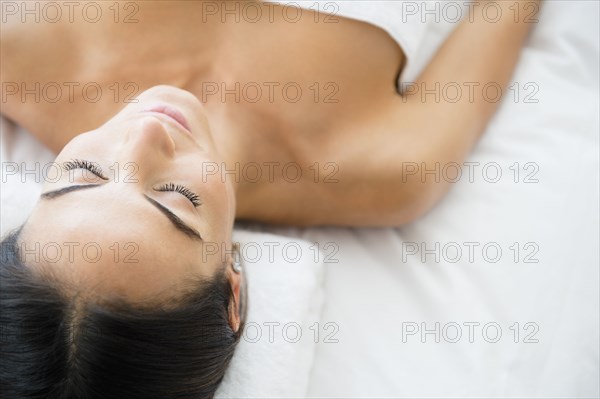 Caucasian woman laying on massage table