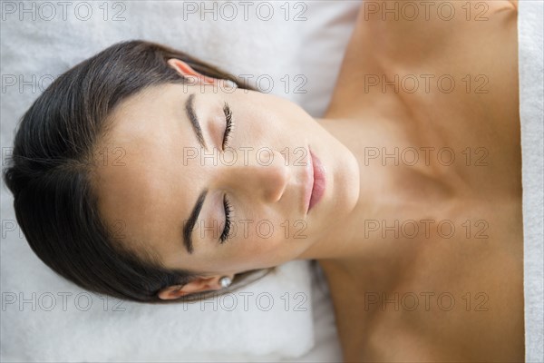 Caucasian woman laying on massage table