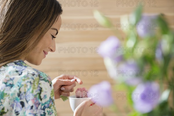 Caucasian woman drinking cup of tea