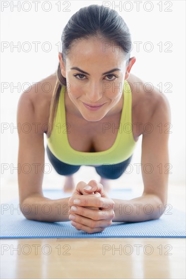 Caucasian woman exercising on yoga mat