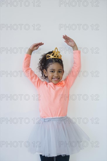 Smiling mixed race ballerina posing in tiara