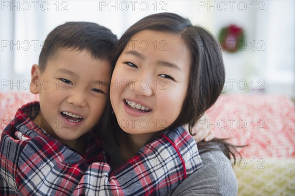 Asian brother and sister hugging