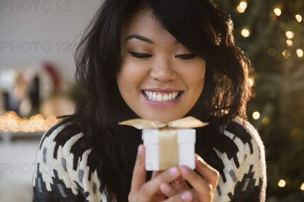 Pacific Islander woman holding small wrapped gift