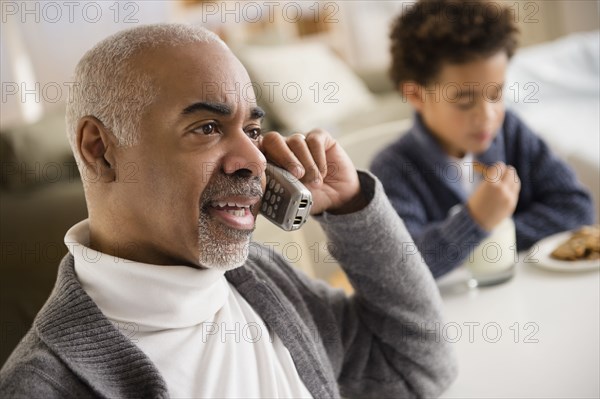 Mixed race man talking on telephone