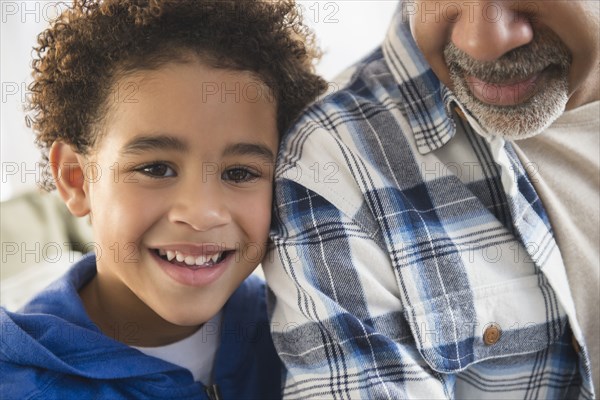 Close up of mixed race grandfather and grandson smiling