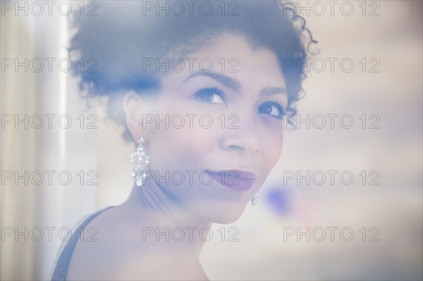 Mixed race woman wearing evening gown and earrings