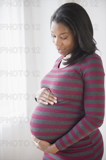 Black pregnant woman admiring her stomach