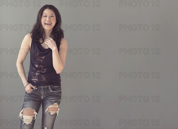 Mixed race woman wearing ripped jeans